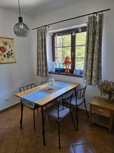 a dining room with a table and chairs and a window at Apartment Barbora 2 in Ružomberok