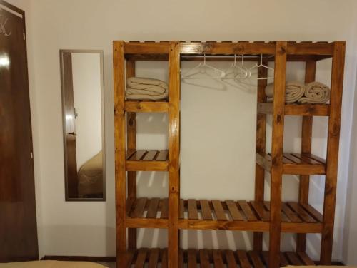 a wooden bunk bed in a room with a mirror at Cabaña Lo de Mingo in San Antonio de Areco