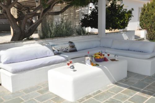 a white couch sitting on a patio with a table at Katikies 22 in Pissouri