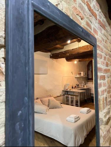 a bedroom with a bed in a brick wall at Antica Dimora Vicolo del Tempio in Spina