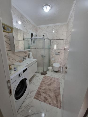 y baño con ducha y lavadora. en Egem House, en Datça