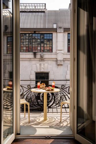 an open window with a table with food on a balcony at Agave in Centrale in Milan