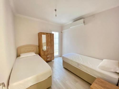 a bedroom with two beds and a window at Egem House in Datca