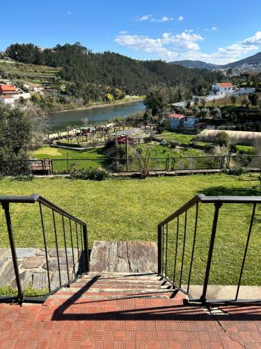 a staircase with a view of a river and a field at Casa Daniel in Pedorido