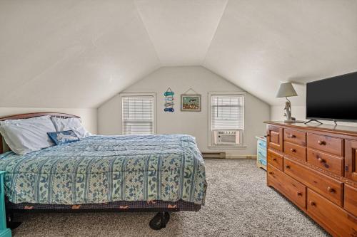 a bedroom with a bed and a dresser with a tv at Lazy Days - Pet friendly with screened gazebo! in Deep Hole