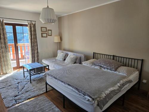 a bedroom with a bed and a couch at Apartment Barbora 2 in Ružomberok