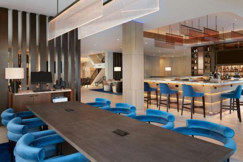 a conference room with a wooden table and blue chairs at Kingston Marriott Hotel in Kingston
