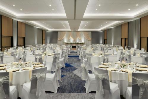 a banquet hall with white tables and chairs at Kingston Marriott Hotel in Kingston
