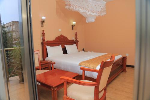 a bedroom with a bed and a sliding glass door at Central Jimma Hotel in Jīma