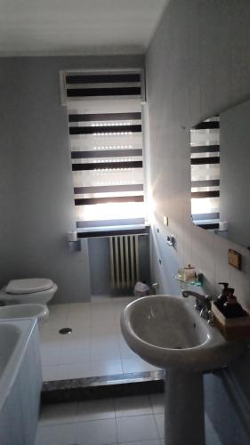 a bathroom with a sink and a toilet and a window at B&B home vintage in Marconia