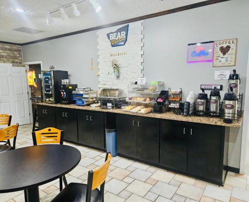 a coffee shop with a counter and tables and chairs at Travelodge by Wyndham Wytheville in Wytheville
