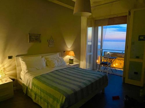 a bedroom with a bed with a view of the ocean at Acquasalata in Salerno