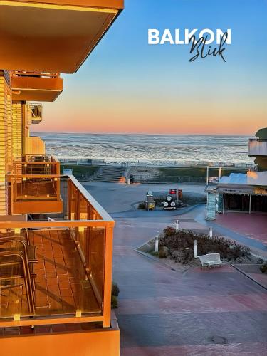 a view of the ocean from the balcony of a building at Duhnerherz Bestlage im Zentrum,am Strand Duhnen, Balkon mit Meerblick,Wlan Parkplatz und Fahrradabstellraum Bettwäsche und Handtücher inkl in Cuxhaven