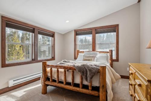 a bedroom with a wooden bed and windows at Philipsburg Family & Couples Cabin Ski Hike Relax in Philipsburg