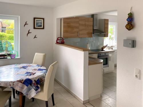 a kitchen with a table and a dining room at Meine Kaptän-Kajüte in Neßmersiel