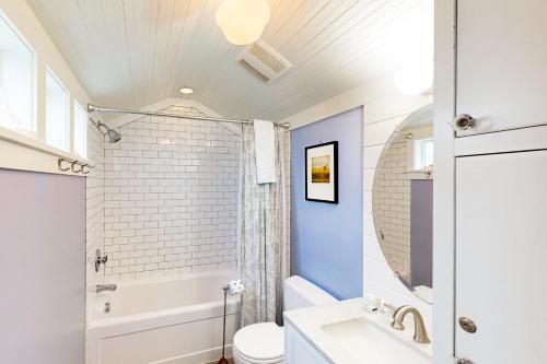 a bathroom with a white toilet and a sink at Rockaway Beach Bungalow in Rockaway Beach