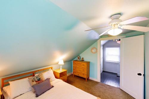 a bedroom with a ceiling fan and a bed at Rockaway Beach Bungalow in Rockaway Beach