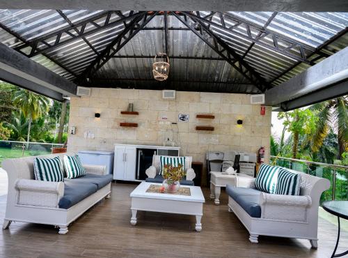 a living room with couches and a fireplace at villas ecologicas hacienda vista linda in Cabrera