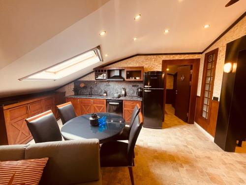 a kitchen with a table and some chairs and a refrigerator at Retro, two bedroom and livingroom on Main Street in Çekmeköy