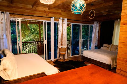 a bedroom with a bed and a large window at villas ecologicas hacienda vista linda in Cabrera