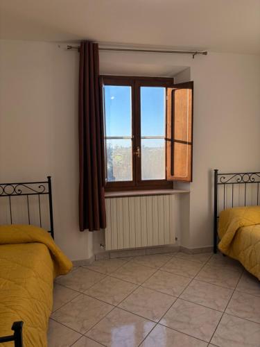 En eller flere senge i et værelse på Agriturismo Sant'Adriano