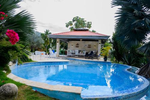 a swimming pool in a yard with a gazebo at villas ecologicas hacienda vista linda in Cabrera
