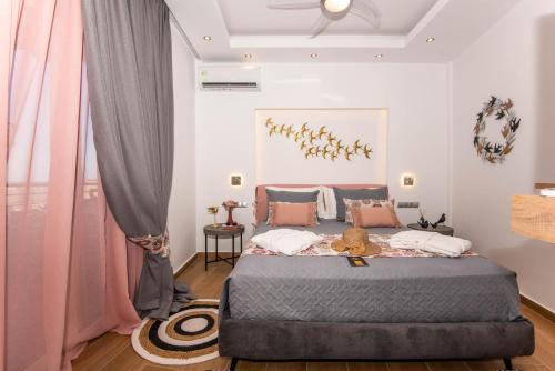 a bedroom with a large bed with pink curtains at Lovebirds Luxury Apartment in Rethymno Town