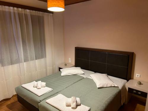 a bedroom with a large bed with towels on it at Christodoulos Villa in Agios Georgios