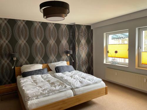 a bedroom with a bed and a window at Ferienwohnung Diemelblick in Trendelburg