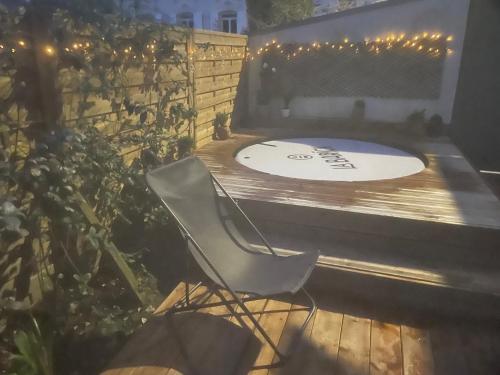 a chair sitting on a deck with a frisbee at côte et mer et Spa in Sainte-Adresse
