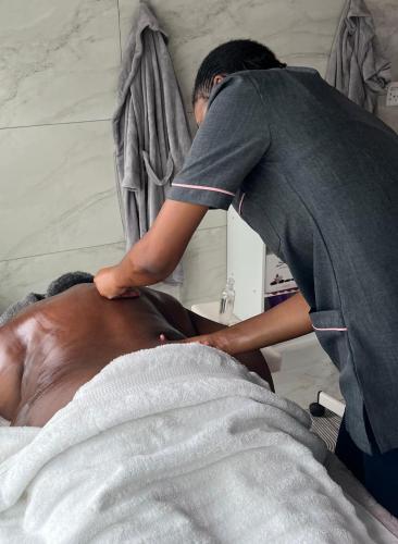 a man in a hospital bed getting a massage at Semeni Asante Guesthouse in Johannesburg