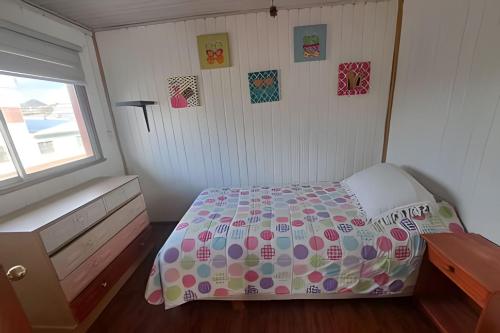 a small bedroom with a bed and a window at Casa Barrio estación in Temuco
