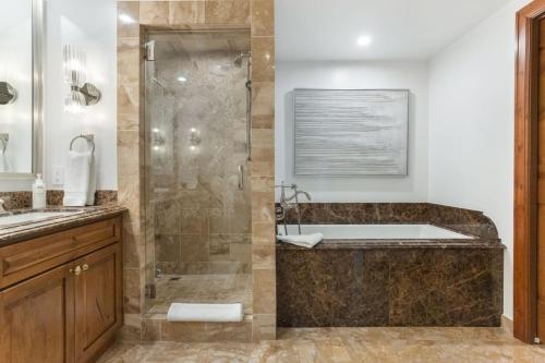 a bathroom with a shower and a bath tub at Ritz Carlton Luxe 3 bed 4 bath in Vail