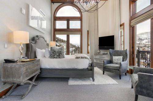 a bedroom with a bed and a desk and a chair at Luxury Ritz Carlton Condo with Views in Vail