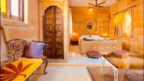 a living room with a bed and a couch at The Blue House in Jodhpur