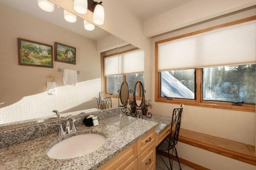 a bathroom with a sink and a large mirror at Stunning Mountain Retreat with View and Private Hot Tub in Tabernash
