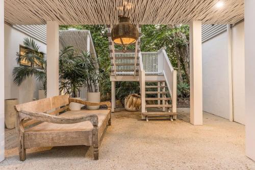 a porch with a staircase and a couch and a chair at Peter St South Golden Beach Abode Family Luxury at Beach in South Golden Beach