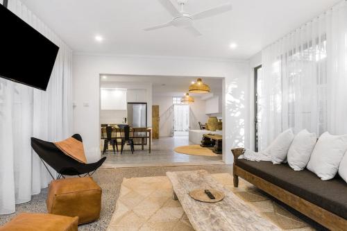 a living room with a couch and a table at Peter St South Golden Beach Abode Family Luxury at Beach in South Golden Beach