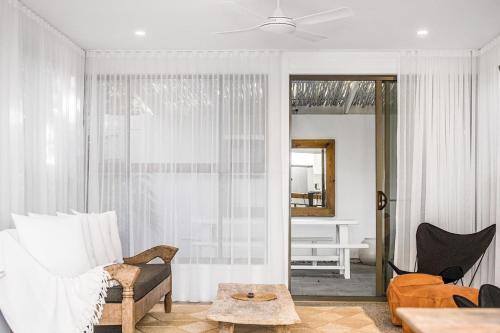 a living room with a couch and a table at Peter St South Golden Beach Abode Family Luxury at Beach in South Golden Beach