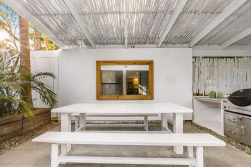 a white table in a room with a mirror at Peter St South Golden Beach Abode Family Luxury at Beach in South Golden Beach