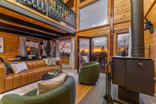a living room with a couch and a stove at The Aspen Ridge Stargazer in Cripple Creek