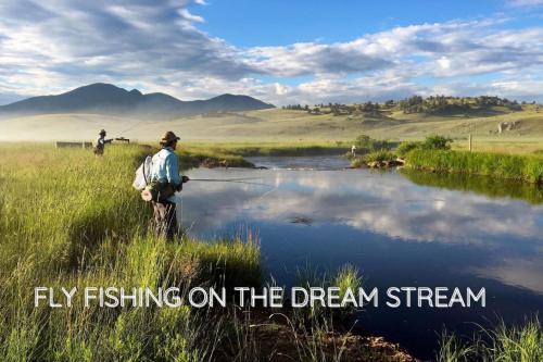 a man fishing on a stream with the words fly fishing on the dream stream at The Aspen Ridge Stargazer in Cripple Creek