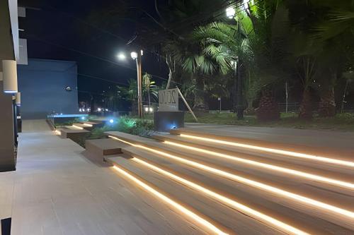 a row of benches at night with lights at Tranquilo Departamento Frente al Movistar Arena in Santiago