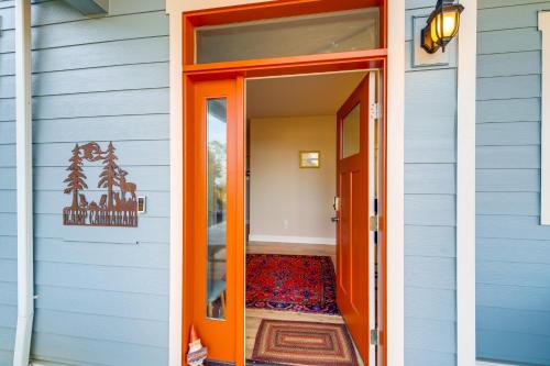 an orange door into a house with a rug at half Mi to Beach Home with Patio in Ocean Shores in Ocean Shores