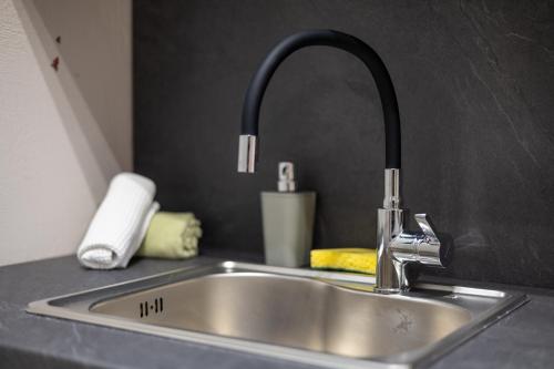 a kitchen sink with a faucet on a counter at Sweet suite in Kalabaka