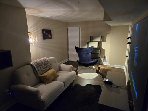 a living room with a couch and a chair at Gorgeous Guest Suite in Marietta!! Minutes from Historic Marietta Square in Marietta