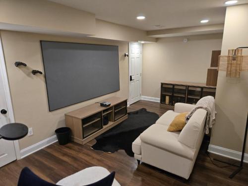 a living room with a couch and a flat screen tv at Gorgeous Guest Suite in Marietta!! Minutes from Historic Marietta Square in Marietta