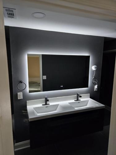 a bathroom with two sinks and a large mirror at Gorgeous Guest Suite in Marietta!! Minutes from Historic Marietta Square in Marietta