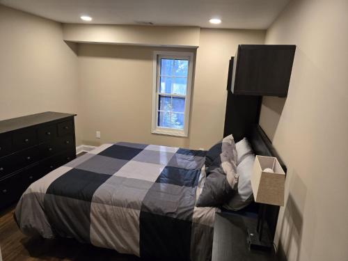 a bedroom with a bed and a dresser and a window at Gorgeous Guest Suite in Marietta!! Minutes from Historic Marietta Square in Marietta