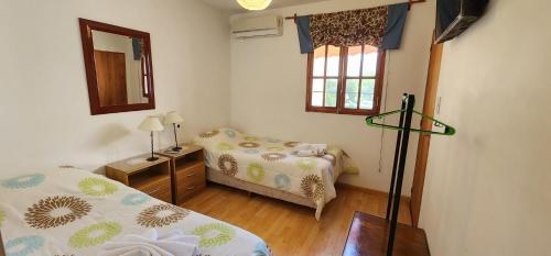 a small room with two beds and a mirror at Sayta Hostal in Salta